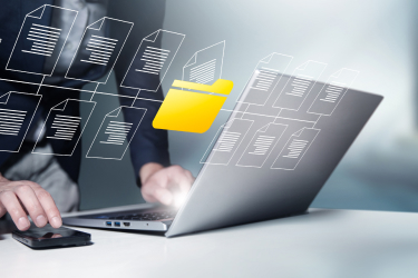 Notebook na stole na ktorom pracuje človek - virtuálne zobrazenie správy súborov